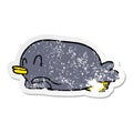 distressed sticker of a penguin lying on belly