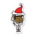 laughing sticker cartoon of a astronaut wearing santa hat