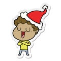 laughing sticker cartoon of a man wearing santa hat