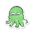 retro distressed sticker of a cartoon alien squid face