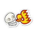 sticker of a cartoon flaming skull