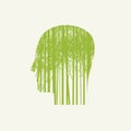 Human head in profile with green young trees