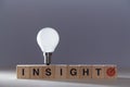 Creative insight. New idea generation, innovation. Originative thinking, innovative. Wooden cubes in line and lightbulb Royalty Free Stock Photo