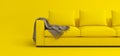 Creative interior layout. Minimalistic style. Modern scandinavian yellow sofa with brown plaid on yellow background. Template for
