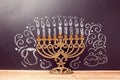 Creative Jewish holiday Hanukkah background with menorah over chalkboard with hand drawing Royalty Free Stock Photo
