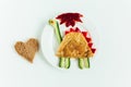 Creative kids food. Omelet,bread,ketchup,vegetables on the white background