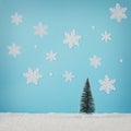 Creative layout with Christmas tree and snowflakes on bright blue background Royalty Free Stock Photo