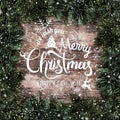 Creative layout frame made of Christmas fir branches with snowflakes on wooden background. Merry Christmas and New Year Royalty Free Stock Photo