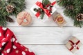 Creative layout frame made of Christmas tree branches, pine cones, gifts, Christmas sweater on white wooden background Royalty Free Stock Photo