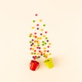 Creative layout of green and red buket with colorful candies. White aesthetic. Royalty Free Stock Photo