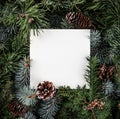 Creative layout made of Christmas tree branches with paper card note, pine cones. Xmas and New Year theme. Royalty Free Stock Photo