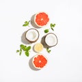 Creative layout made coconut, grapefruit, lemon and mint leaves