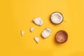 Creative layout made of coconut pieces on yellow background Royalty Free Stock Photo