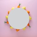 Creative layout made of colorful Easter eggs and carrots with blank paper card. Minimal Easter background. Spring holidays concept Royalty Free Stock Photo