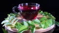 Creative layout made of cup of red tea and tea leafs. Tea time: cup of tea, carcade, karkade, rooibos. Oriental, cozy, ceremony, Royalty Free Stock Photo