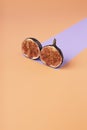 Creative layout made with figs and paper artificial shadow on orange background