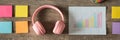 Creative Learning Space Featuring Headphones, Colorful Sticky Notes, and an Organized Progress Graph for Effective Study Royalty Free Stock Photo