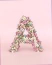 Creative letter A concept made of frash Spring wedding flowers. Flower font concept on pastel pink background