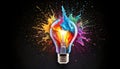 Creative light bulb explodes with colorful paint and splashes Royalty Free Stock Photo