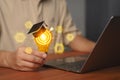 Creative light bulb with graduation cap and digital education icons, symbolizing knowledge, e-learning, innovation Royalty Free Stock Photo