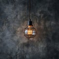 Creative lighting hanging lightbulb on industrial cement background