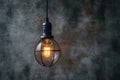 Creative lighting hanging lightbulb on industrial cement background