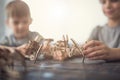 Close up of creative children making wooden figures together