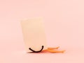 Creative look of woman legs out of paper bag on pink pastel background. Minimal shopping concept. Copy space