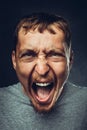 Creative male portrait. Young handsome man is screaming. Radical expression and emotion concept Royalty Free Stock Photo