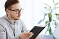 Creative male worker with book at home office Royalty Free Stock Photo