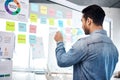 Creative man, sticky note and glass board for schedule tasks, planning or brainstorming at the office. Male person or Royalty Free Stock Photo