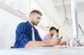 Creative man texting on cellphone at office Royalty Free Stock Photo