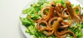 Creative meal for a child, fried sausages in an octopus shape served with fresh gem lettuce