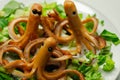 Creative meal for a child, fried sausages in an octopus shape served with fresh gem lettuce