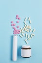 Creative medicine compositions. two types of drugs in the form of capsules and tablets on a gradient background. flat lay, Royalty Free Stock Photo