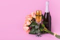 Creative minimal concept with bouquet of beautiful roses, champagne bottle and glass of golden glitters and eyelashes on pastel Royalty Free Stock Photo