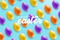Creative minimal Happy Easter layout colorful eggs and the text message ``Happy Easter`` together on the sweet blue background.