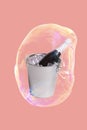 Creative minimal idea with a bottle of champagne in an ice bucket in a soap bubble floating in the air on a trendy colored Royalty Free Stock Photo