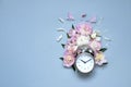 Creative minimalistic composition with a Clock. Alarm clock with peony flowers. Spring time. Time to love. Top view Royalty Free Stock Photo