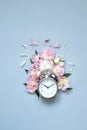 Creative minimalistic composition with a Clock. Alarm clock with peony flowers. Spring time. Time to love. Top view Royalty Free Stock Photo