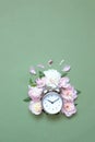 Creative minimalistic composition with a Clock. Alarm clock with peony flowers. Spring time. Time to love. Top view Royalty Free Stock Photo