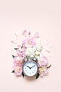 Creative minimalistic composition with a Clock. Alarm clock with peony flowers. Spring time. Time to love. Top view Royalty Free Stock Photo