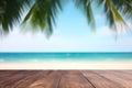 Empty wooden table top in front of blue sky, summer sea with palm leaf blurred bokeh background. Template for product presentation Royalty Free Stock Photo