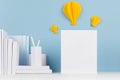 Creative mock up back to school - white stationery, blank letterhead and yellow paper lightbulbs origami as idea on soft blue back Royalty Free Stock Photo