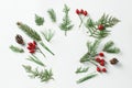 Creative mockup layout made of christmas tree and red holly berries branches with copy space on white. Homemade flat lay concept