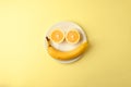 Creative monochrome summer layout made of lemon and banana on white plate on yellow background. Fruit minimal concept. Smile Royalty Free Stock Photo