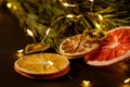 Creative moody holiday Christmas New Year food fruits with dried grapefruit, kiwi, orange and lemon with branch of fir tree