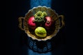 Creative moody shot of fruit and vegitable in a golden basket Royalty Free Stock Photo