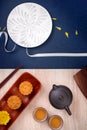 Creative Moon cake Mooncake design inspiration, enjoy the moon in Mid-Autumn festival with pastry and tea on wooden table concept