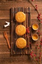 Creative Moon cake Mooncake table design - Chinese traditional pastry with tea cups on wooden background, Mid-Autumn Festival